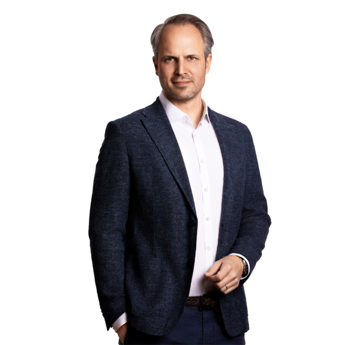 Portraitbild von Jakob le Claire, Senior Partner bei Kemény Boehme Consultants, der mit einer Hand in der Tasche in die Kamera blickt.
