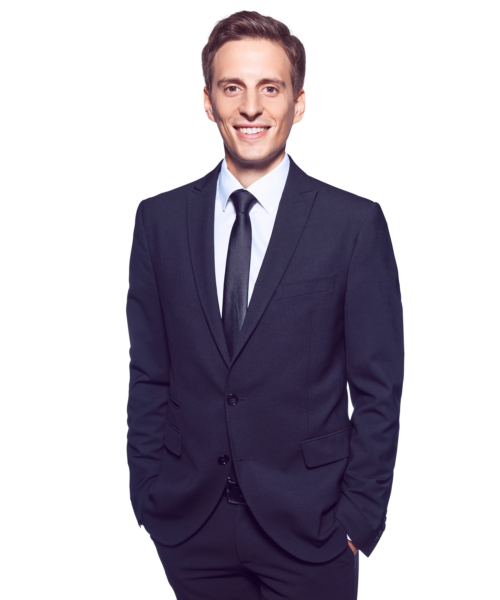 Portrait photo of Victor Gradl, Director at Kemény Boehme Consultants (KBC). A man with short dark brown hair, smiling broadly and warmly at the camera. He is wearing a dark suit with a light blue shirt and black tie, with both hands in his pants pockets.